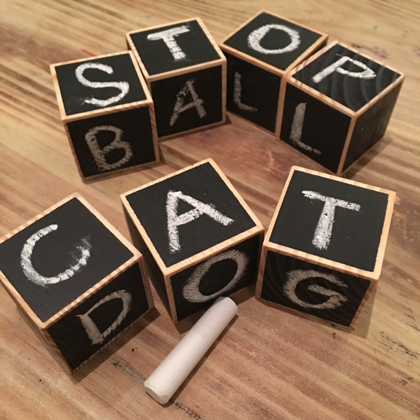 Children's wooden blocks spelling stop, ball, cat, and dog