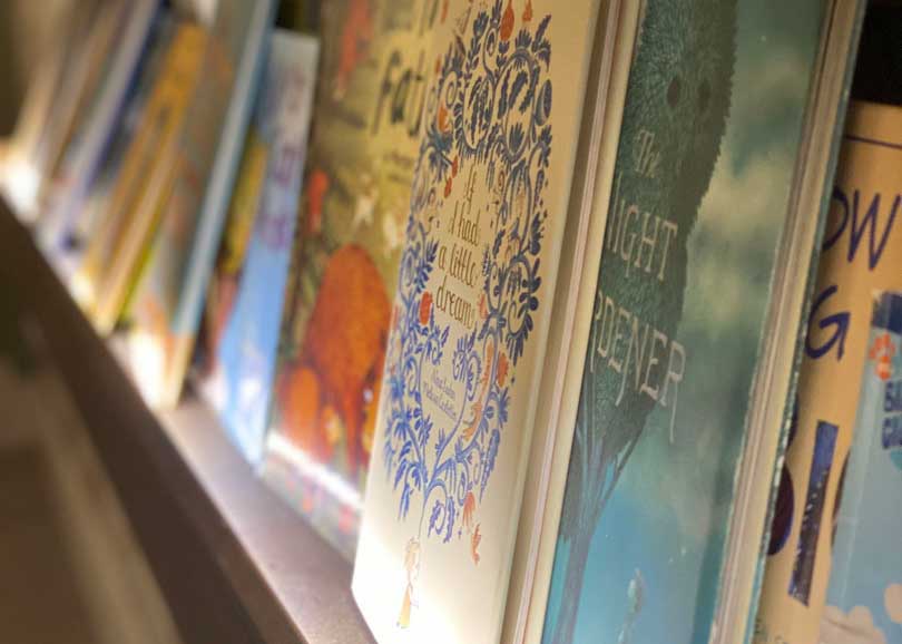 Close up of children's books on a wall rack in Book Nook Enrichment