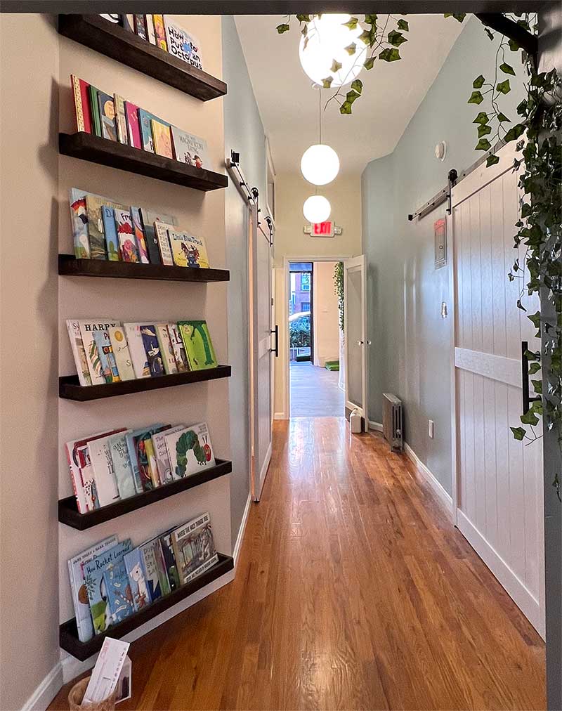 Hallway with book-lined shelves in Book Nook Park Slope