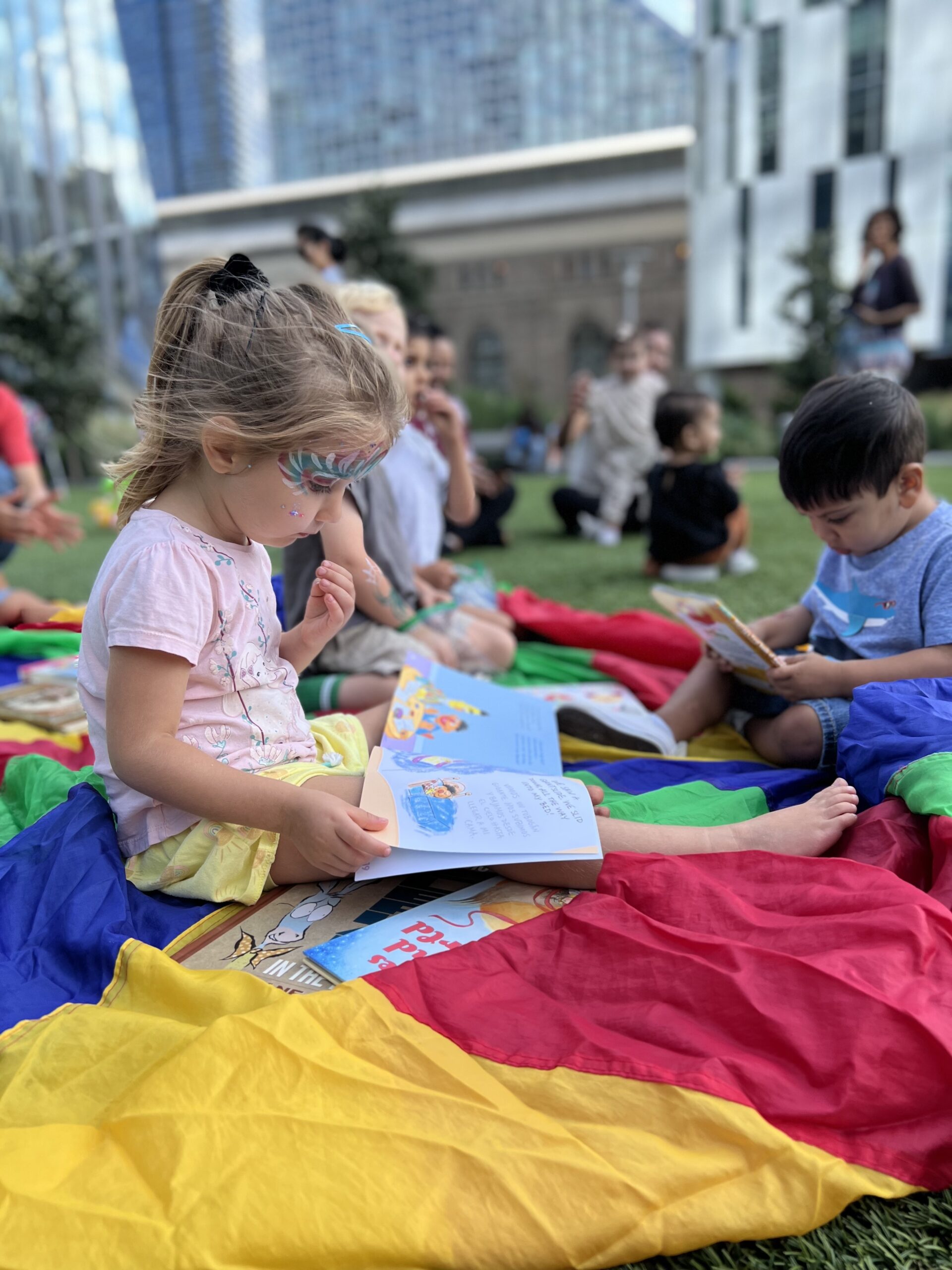 Children reading at a summer event.